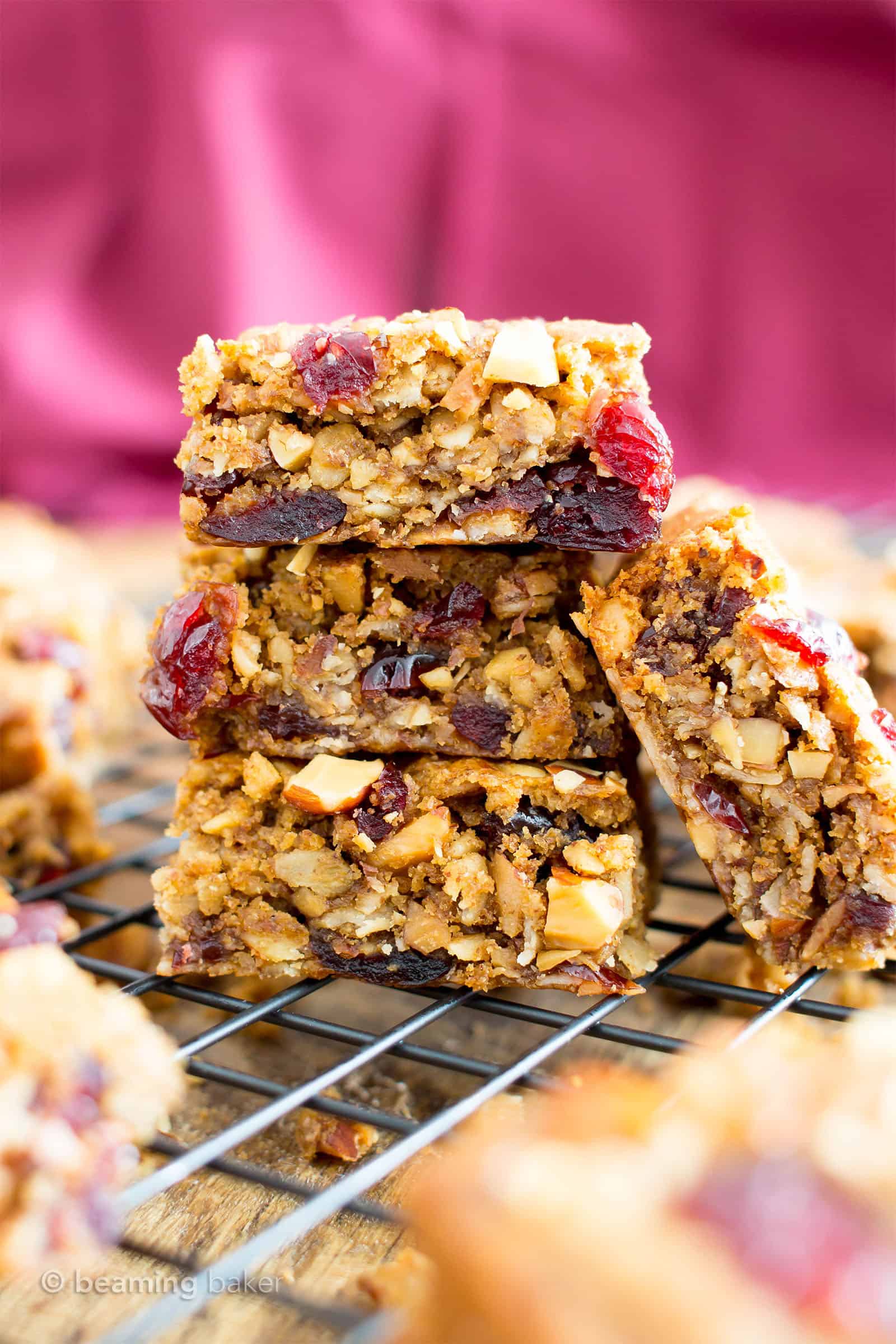 baked almond butter breakfast bars in a stack with one breakfast bar on the side