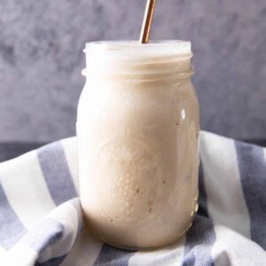 Protein shake recipe in a glass served with a straw