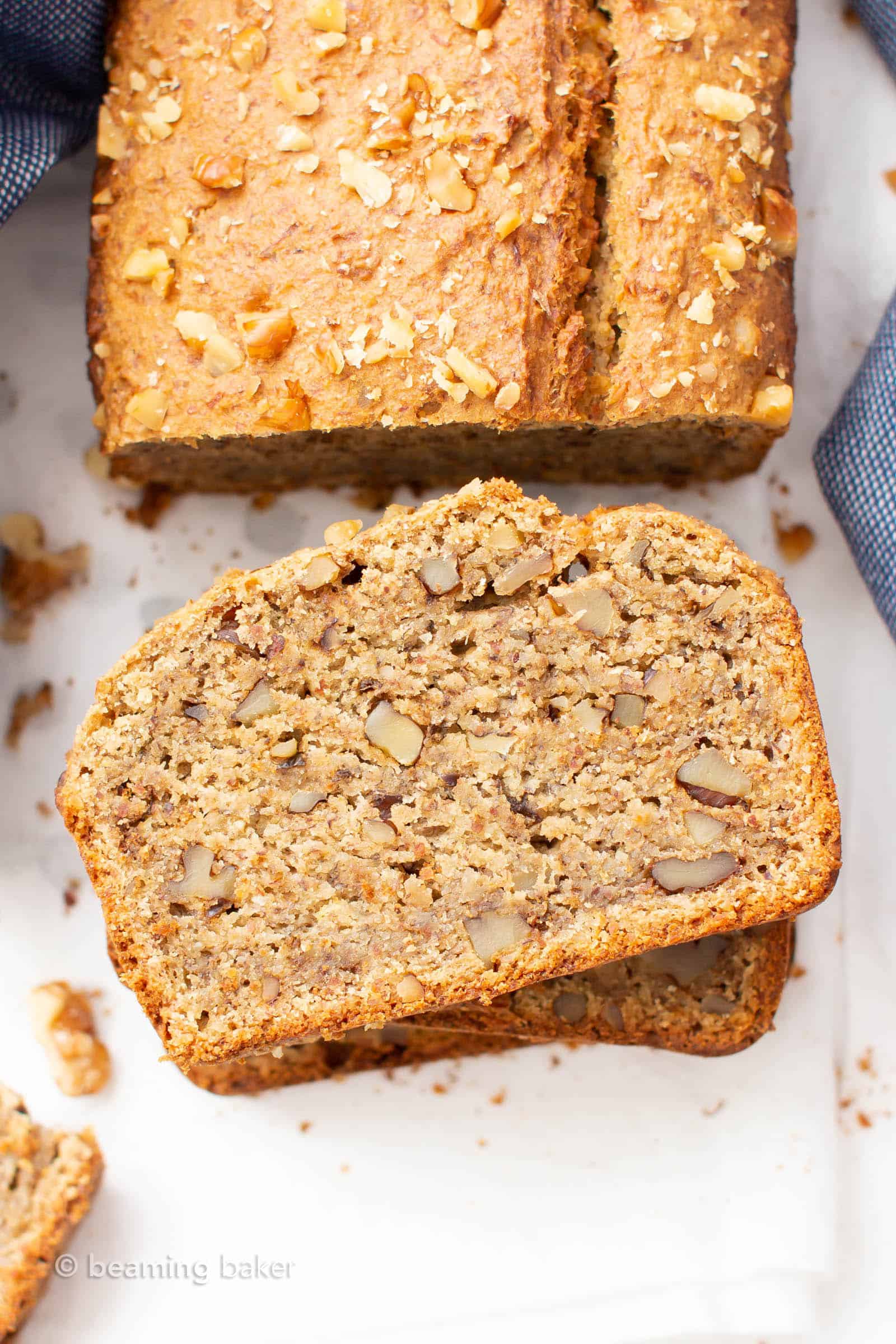 Overhead shot of stack of vegan gluten free banana bread slices with remainder of loaf behind it