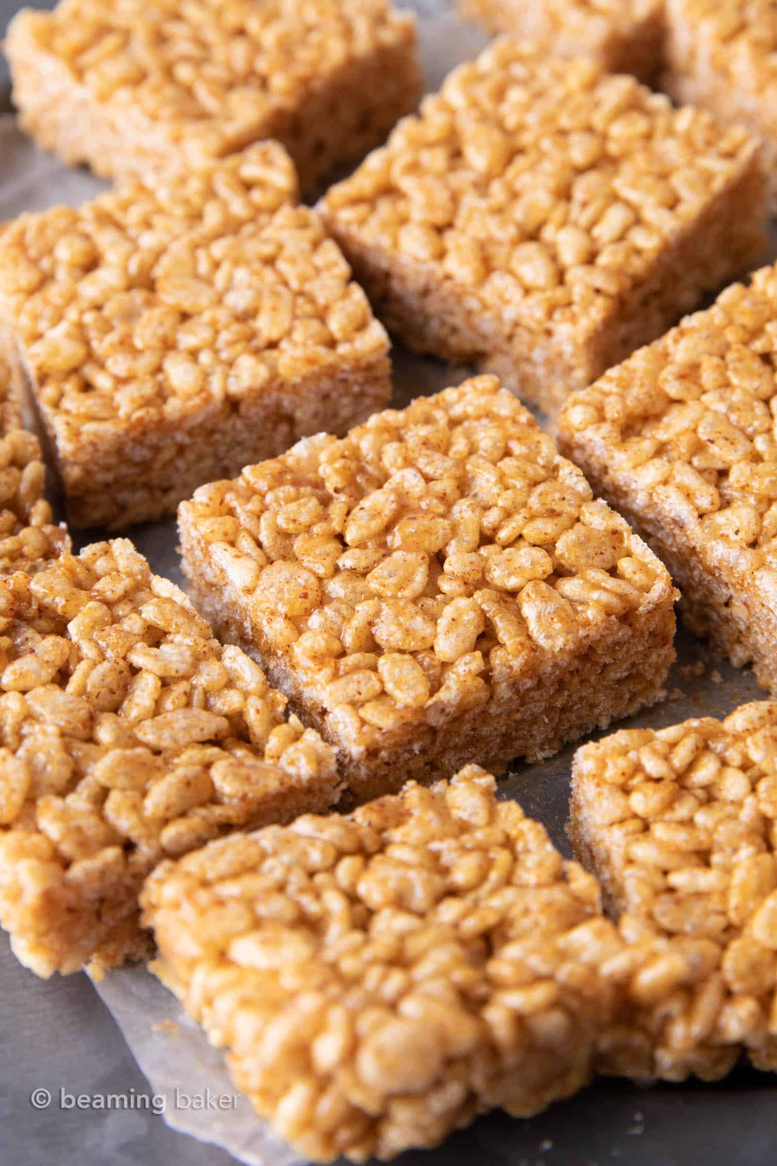 A dozen healthy rice krispie treats on wax paper