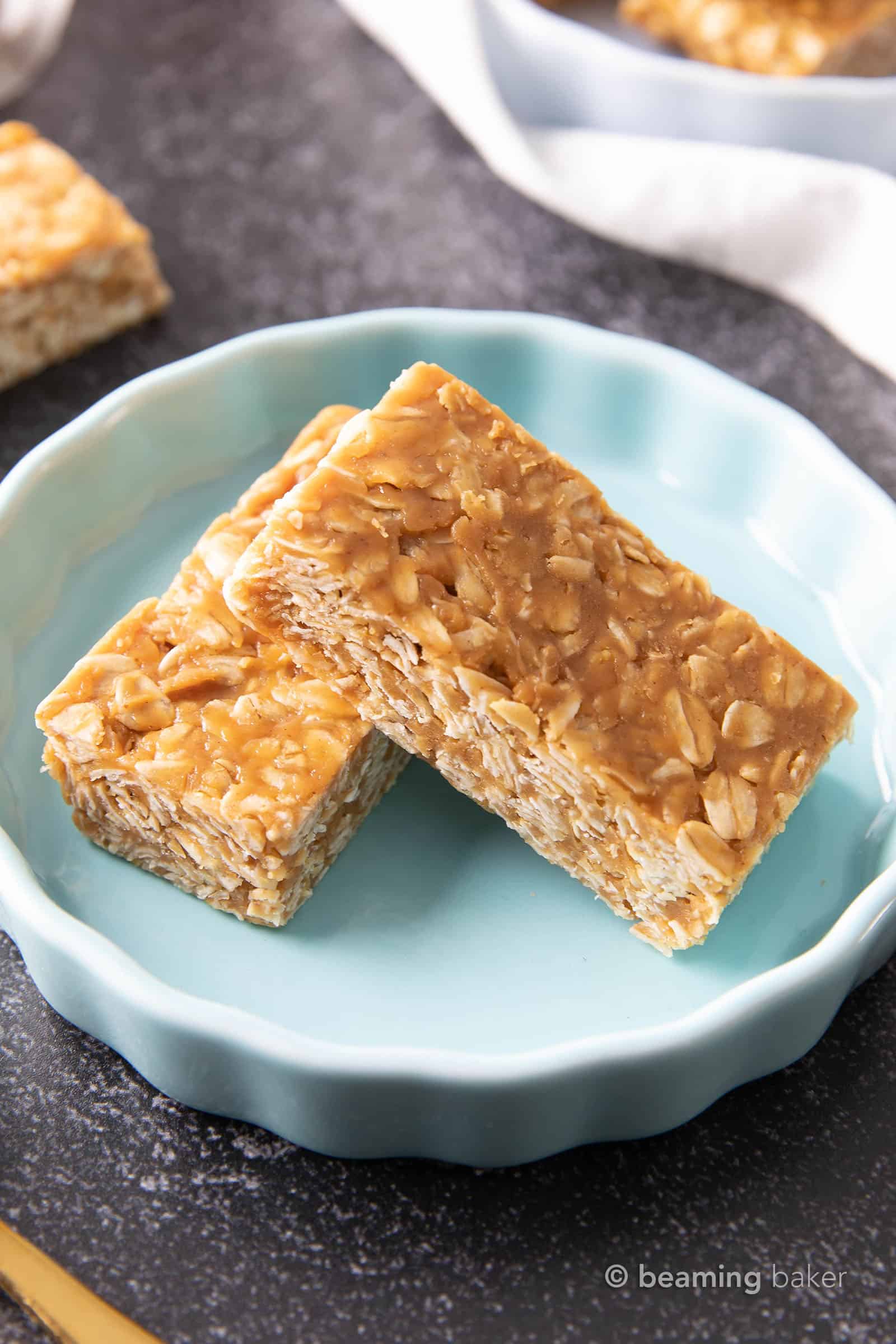 3 Ingredient No Bake Peanut Butter Granola Bars: this homemade peanut butter granola bars recipe is so EASY! The best oatmeal peanut butter granola bars recipe without honey, that tastes like honey roasted peanuts. Healthy, Vegan, Gluten Free. #PeanutButter #GranolaBars #NoBake #Oatmeal | Recipe at BeamingBaker.com