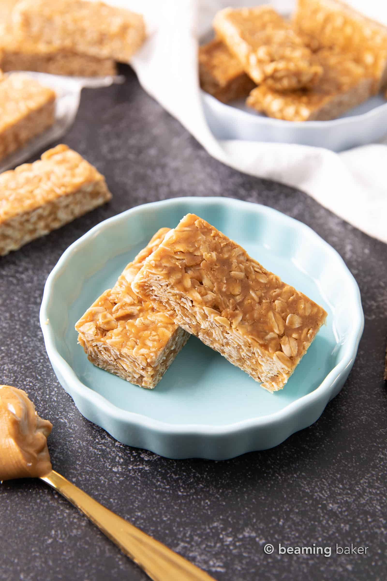 3 Ingredient No Bake Peanut Butter Granola Bars (GF): this homemade peanut butter granola bars recipe is so EASY! The best oatmeal peanut butter granola bars recipe without honey, that tastes like honey roasted peanuts. Healthy, Vegan, Gluten Free. #PeanutButter #GranolaBars #NoBake #Oatmeal | Recipe at BeamingBaker.com