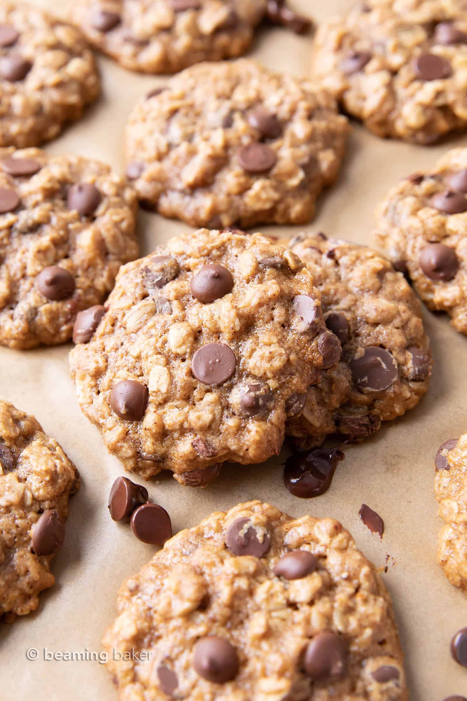Easy Healthy Oatmeal Chocolate Chip Cookies: this easy healthy oatmeal chocolate chip cookies recipe yields chewy cookies with crispy edges and lots of chocolate chips! Vegan, Gluten-Free, Dairy-Free, Healthy. #Healthy #OatmealCookies #HealthyCookies #ChocolateChip | Recipe at BeamingBaker.com