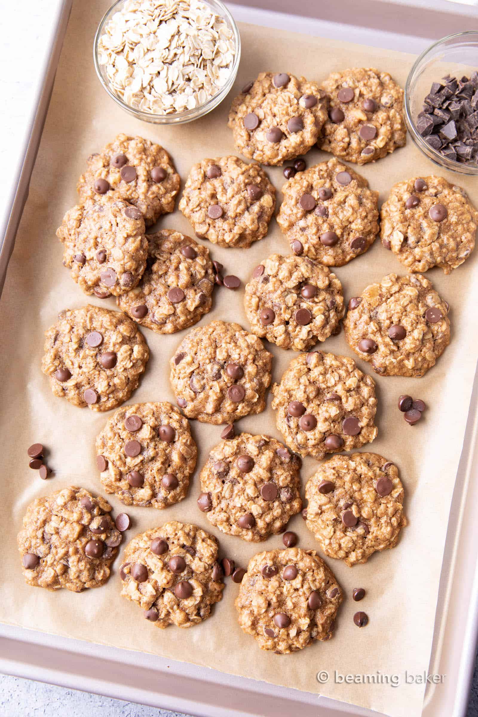 Easy Healthy Oatmeal Chocolate Chip Cookies: this easy healthy oatmeal chocolate chip cookies recipe yields chewy cookies with crispy edges and lots of chocolate chips! Vegan, Gluten-Free, Dairy-Free, Healthy. #Healthy #OatmealCookies #HealthyCookies #ChocolateChip | Recipe at BeamingBaker.com