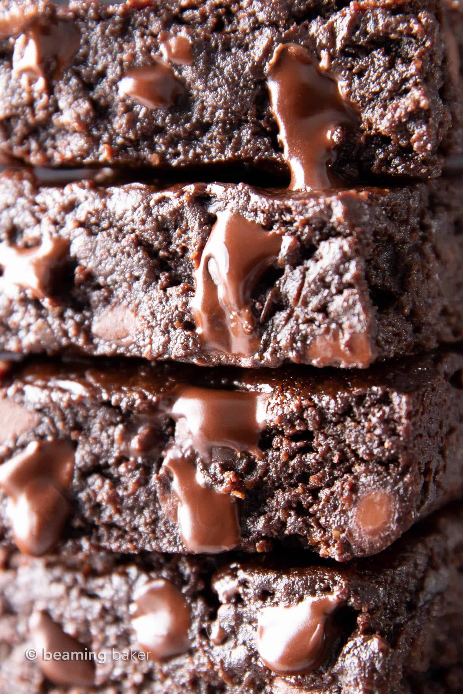 super closeup shot of vegan chocolate chips melting down a stack of vegan gluten free brownies
