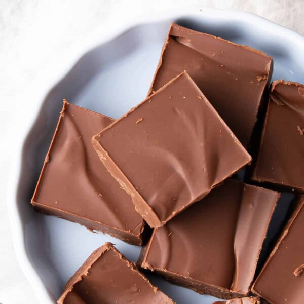 Squares of vegan fudge on a white plate