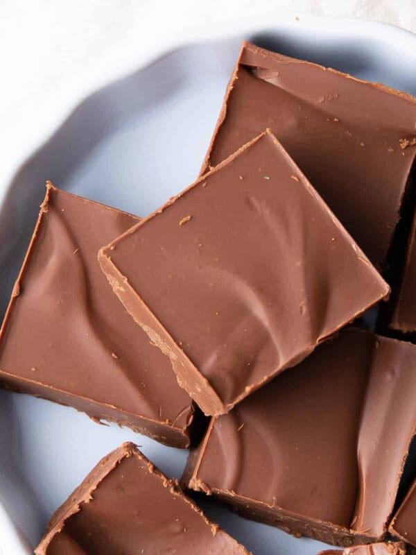 Squares of vegan fudge on a white plate