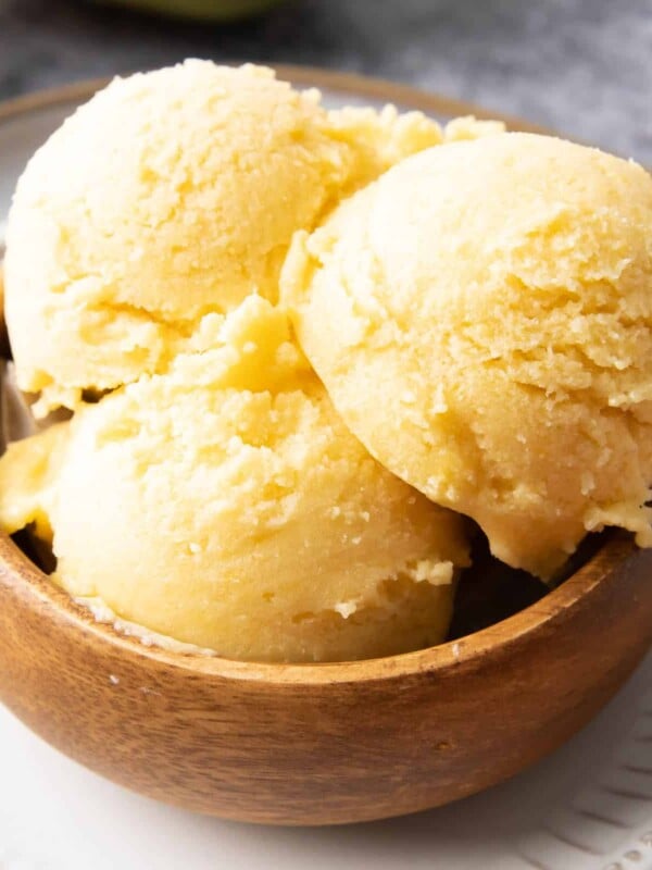 Homemade Mango Ice Cream: this 3 ingredient mango ice cream recipe is super EASY! 5 mins of prep for the best mango ice cream: rich & creamy with big mango flavor! Vegan, Dairy-Free, Healthy #Mango #IceCream #Vegan #DairyFree | Recipe at BeamingBaker.com