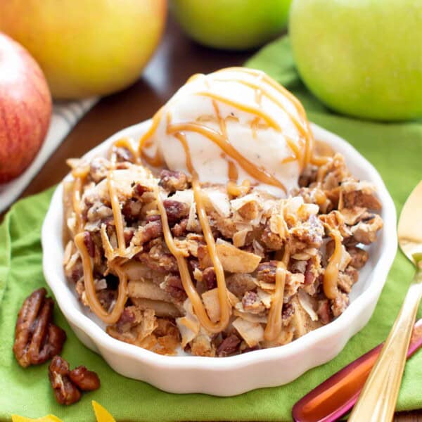 A simple and easy paleo apple crisp recipe that yields gooey cinnamon apple filling with a delicious crisp topping! The best paleo apple crisp made with whole ingredients. #AppleCrisp #Paleo #Apples #AppleCrumble | Recipe at BeamingBaker.com