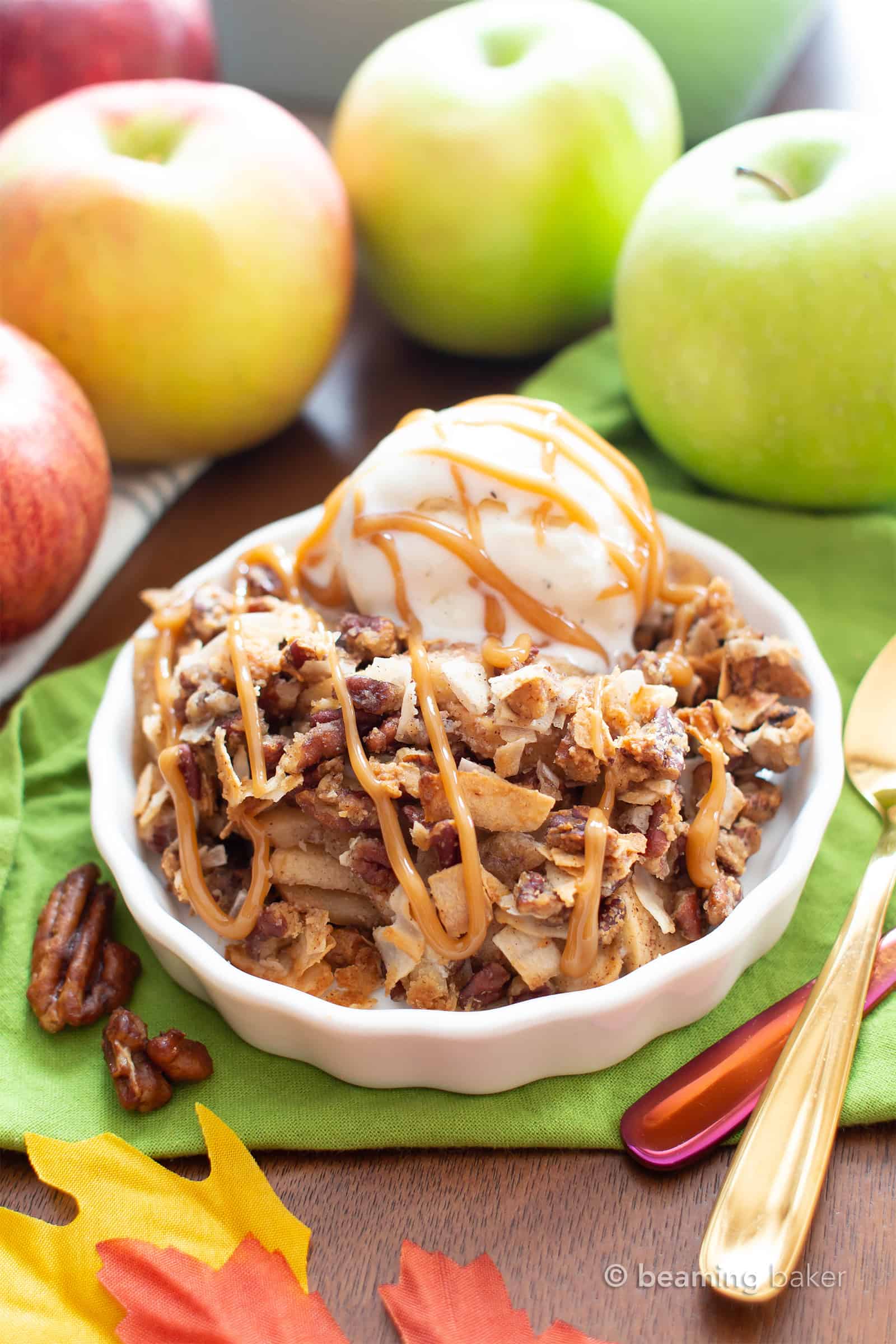 A simple and easy paleo apple crisp recipe that yields gooey cinnamon apple filling with a delicious crisp topping! The best paleo apple crisp made with whole ingredients. #AppleCrisp #Paleo #Apples #AppleCrumble | Recipe at BeamingBaker.com