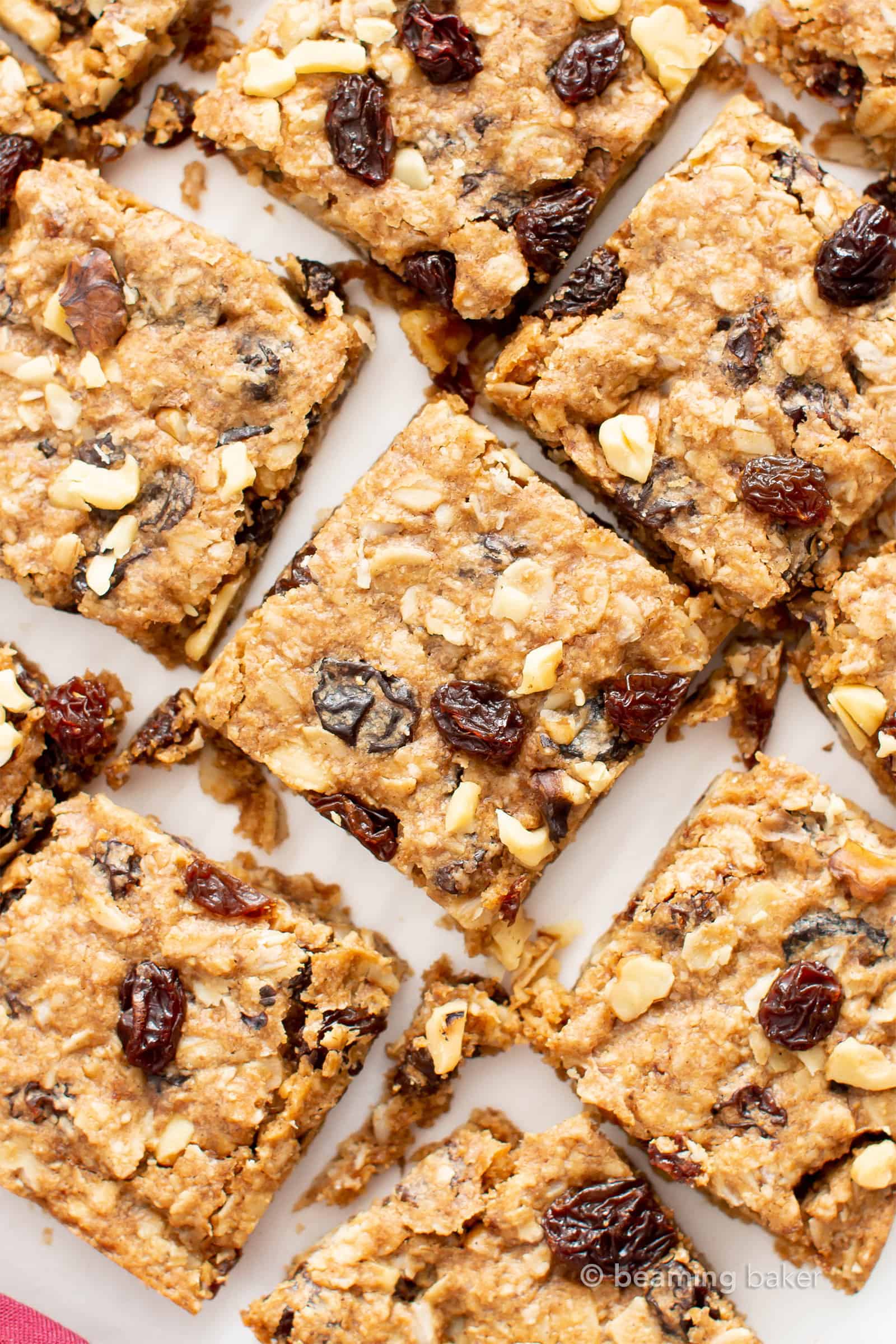 The BEST Vegan Oatmeal Raisin Bars Recipe: chewy centers, crispy edges, packed with raisins & oats! The ultimate gluten free oatmeal cookie bars—healthy, homemade & easy! #Oatmeal #Vegan #GlutenFree #Cookies | Recipe at BeamingBaker.com
