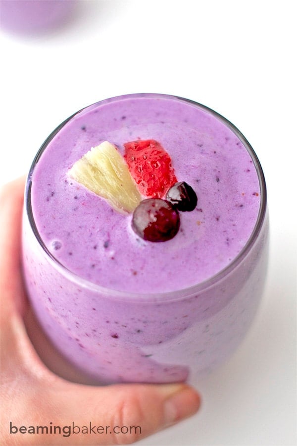 Refreshing, sweet, protein-packed Pineapple Berry Smoothies: made with Greek yogurt, strawberries, blueberries and almond milk, these smoothies are the perfect fruity boost. BEAMINGBAKER.COM #healthy #gymfuel
