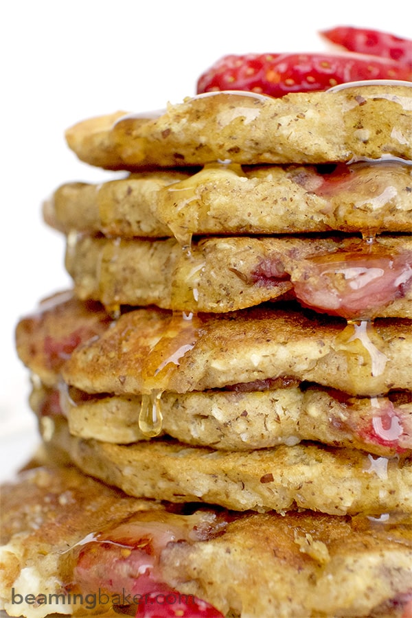 An easy recipe for the BEST fluffy strawberry white chocolate chip pancakes! Made with simple ingredients: oat flour, almond meal, whole wheat flour and coconut. BEAMINGBAKER.COM