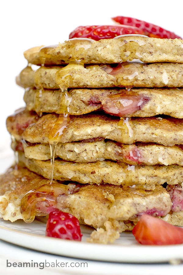 An easy recipe for the BEST fluffy strawberry white chocolate chip pancakes! Made with simple ingredients: oat flour, almond meal, whole wheat flour and coconut. BEAMINGBAKER.COM