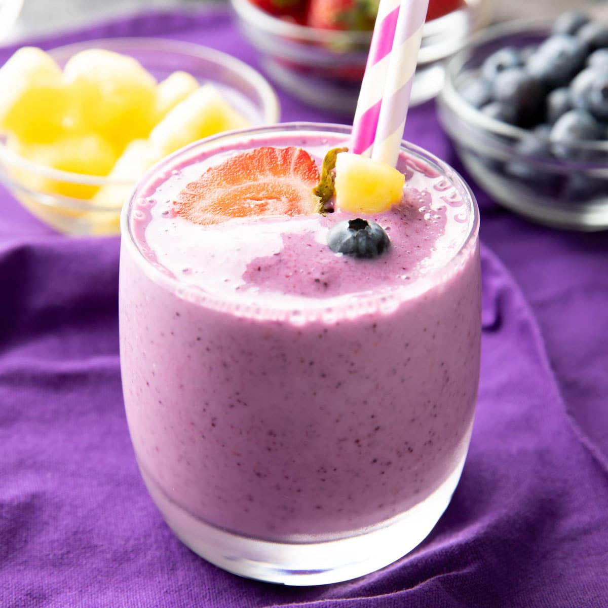 Berry Pineapple Smoothie served with pineapples, blueberries, and strawberries