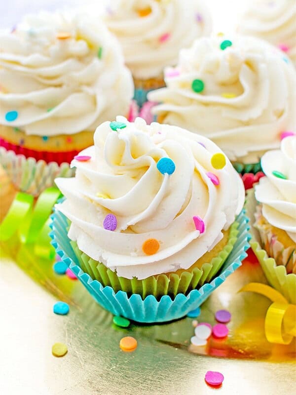 Funfetti Birthday Cupcakes: Moist, classic white cupcakes speckled with funfetti sprinkles and topped with luscious, fluffy vanilla frosting. BEAMINGBAKER.COM #birthday #cupcakes