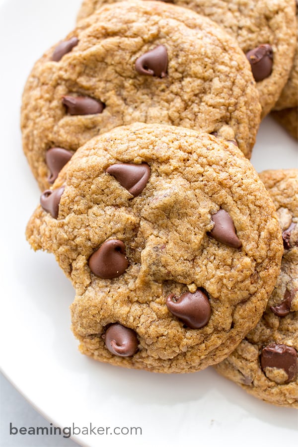 Soft, chewy, crispy on the bottom Healthier Vegan Chocolate Chip Cookies. Made with oat flour, whole wheat flour, organic unrefined coconut sugar and coconut oil. BEAMINGBAKER.COM #VEGAN