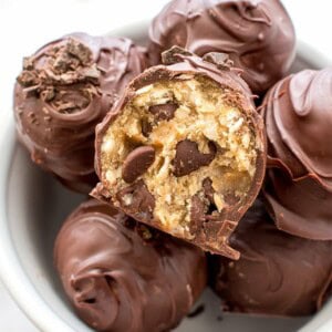 Chocolate Chip Cookie Dough Truffles (V+GF): Decadent chocolate chip cookie dough bites wrapped in a velvety blanket of rich, dark, indulgent chocolate. BEAMINGBAKER.COM. #Vegan #GlutenFree