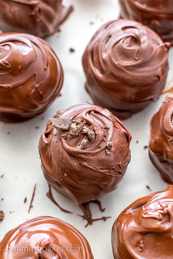 Chocolate Chip Cookie Dough Truffles (V+GF): Decadent chocolate chip cookie dough bites wrapped in a velvety blanket of rich, dark, indulgent chocolate. BEAMINGBAKER.COM. #Vegan #GlutenFree