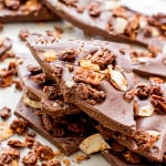 Richly indulgent, melt in your mouth good chocolate covered coconut granola enrobed in a thick layer of chocolate. BEAMINGBAKER.COM #Vegan #GlutenFree