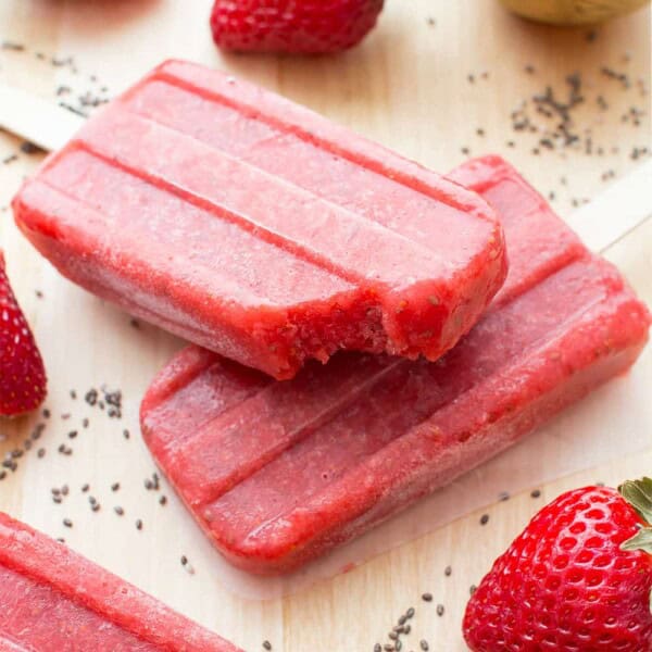 Vegan Strawberry Chia Seed Popsicles (V+GF): a 3 ingredient recipe for delicious, refreshing strawberry popsicles bursting with chia seeds. #Vegan #DairyFree #GlutenFree | BeamingBaker.com