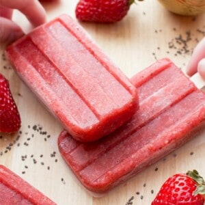 Vegan Strawberry Chia Seed Popsicles (V+GF): a 3 ingredient recipe for delicious, refreshing strawberry popsicles bursting with chia seeds. #Vegan #DairyFree #GlutenFree | BeamingBaker.com