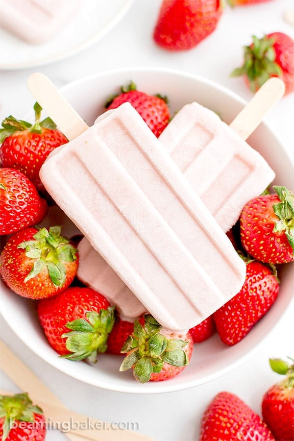 Vegan Strawberry Coconut Popsicles (V, GF, DF): a 4 ingredient, plant-based recipe for creamy, refreshing popsicles bursting with strawberry and coconut flavor. #Vegan #DairyFree #Paleo #GlutenFree | BeamingBaker.com