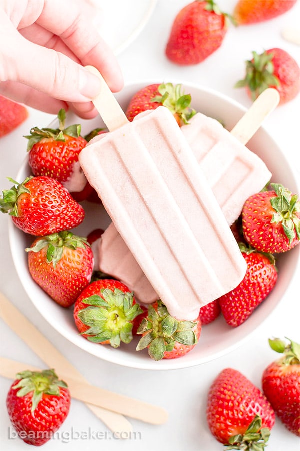 Vegan Strawberry Coconut Popsicles (V, GF, DF): a 4 ingredient, plant-based recipe for creamy, refreshing popsicles bursting with strawberry and coconut flavor. #Vegan #DairyFree #Paleo #GlutenFree | BeamingBaker.com