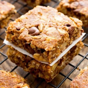 Vegan Breakfast Bars stacked on each other on top of a black cooling rack.