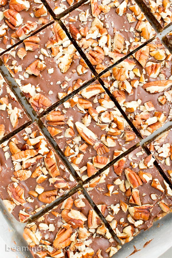 No Bake Paleo Chocolate Pecan Bars (V, GF, Paleo): a 5-ingredient, no bake recipe for deliciously textured pecan bars topped with a thick layer of chocolate and nuts. #Paleo #Vegan #GlutenFree #DairyFree | BeamingBaker.com