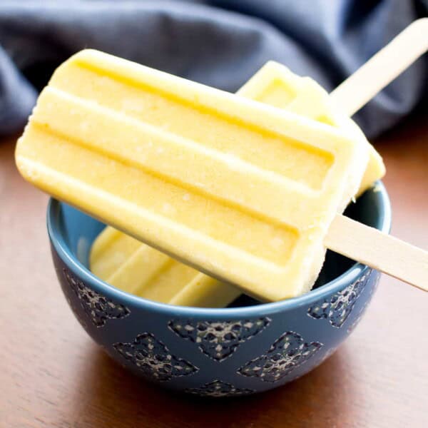 Mango Coconut Cream Popsicles (V, GF, DF): a 3 ingredient recipe for creamy and refreshing popsicles packed with mango and coconut! #Paleo #Vegan #DairyFree #GlutenFree | BeamingBaker.com