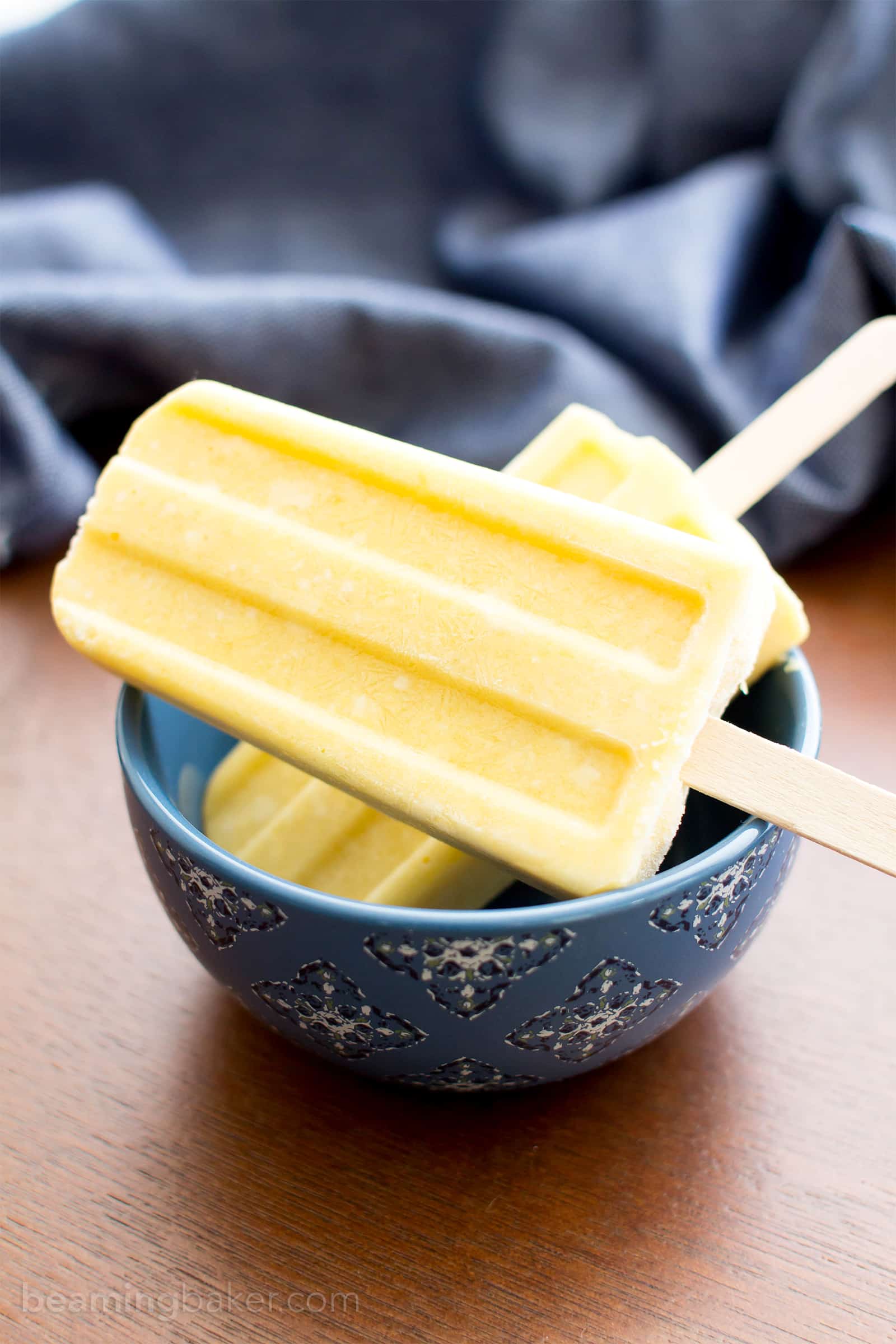 Mango Coconut Cream Popsicles (V, GF, DF): a 3 ingredient recipe for creamy and refreshing popsicles packed with mango and coconut! #Paleo #Vegan #DairyFree #GlutenFree | BeamingBaker.com