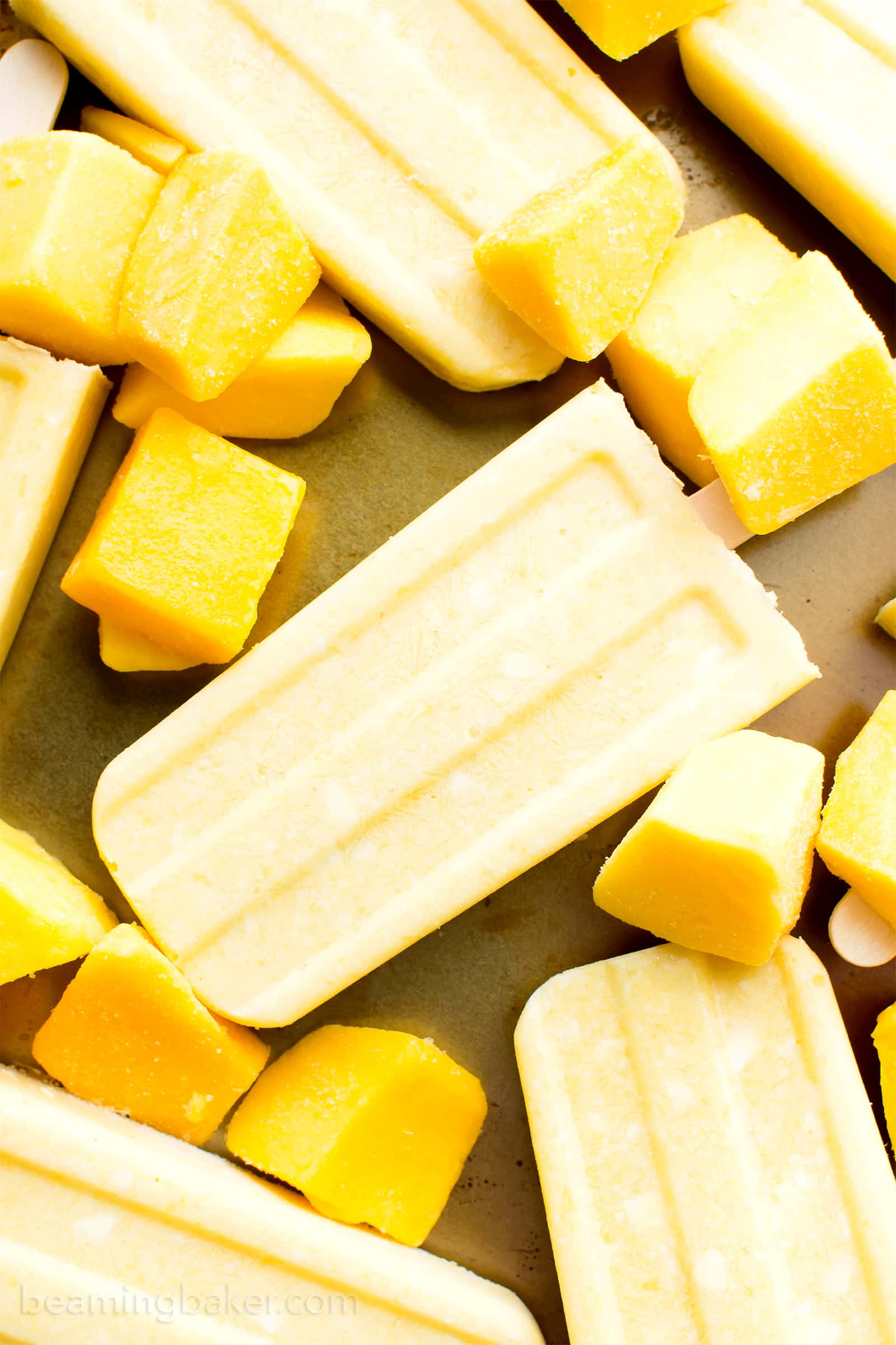 Mango Coconut Cream Popsicles (V, GF, DF): a 3 ingredient recipe for creamy and refreshing popsicles packed with mango and coconut! #Paleo #Vegan #DairyFree #GlutenFree | BeamingBaker.com