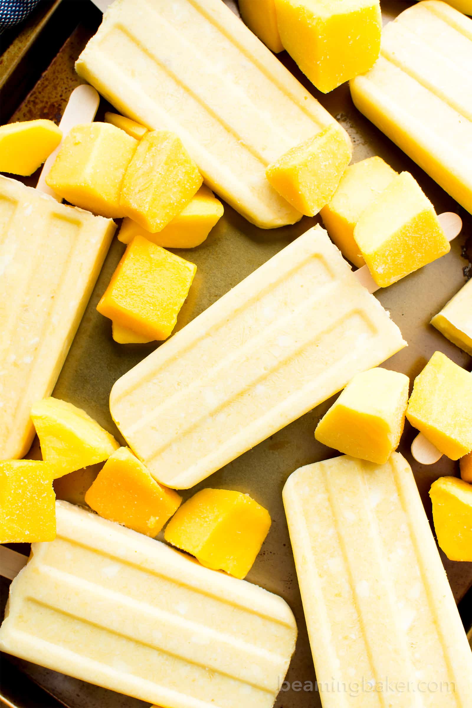 Mango Coconut Cream Popsicles (V, GF, DF): a 3 ingredient recipe for creamy and refreshing popsicles packed with mango and coconut! #Paleo #Vegan #DairyFree #GlutenFree | BeamingBaker.com