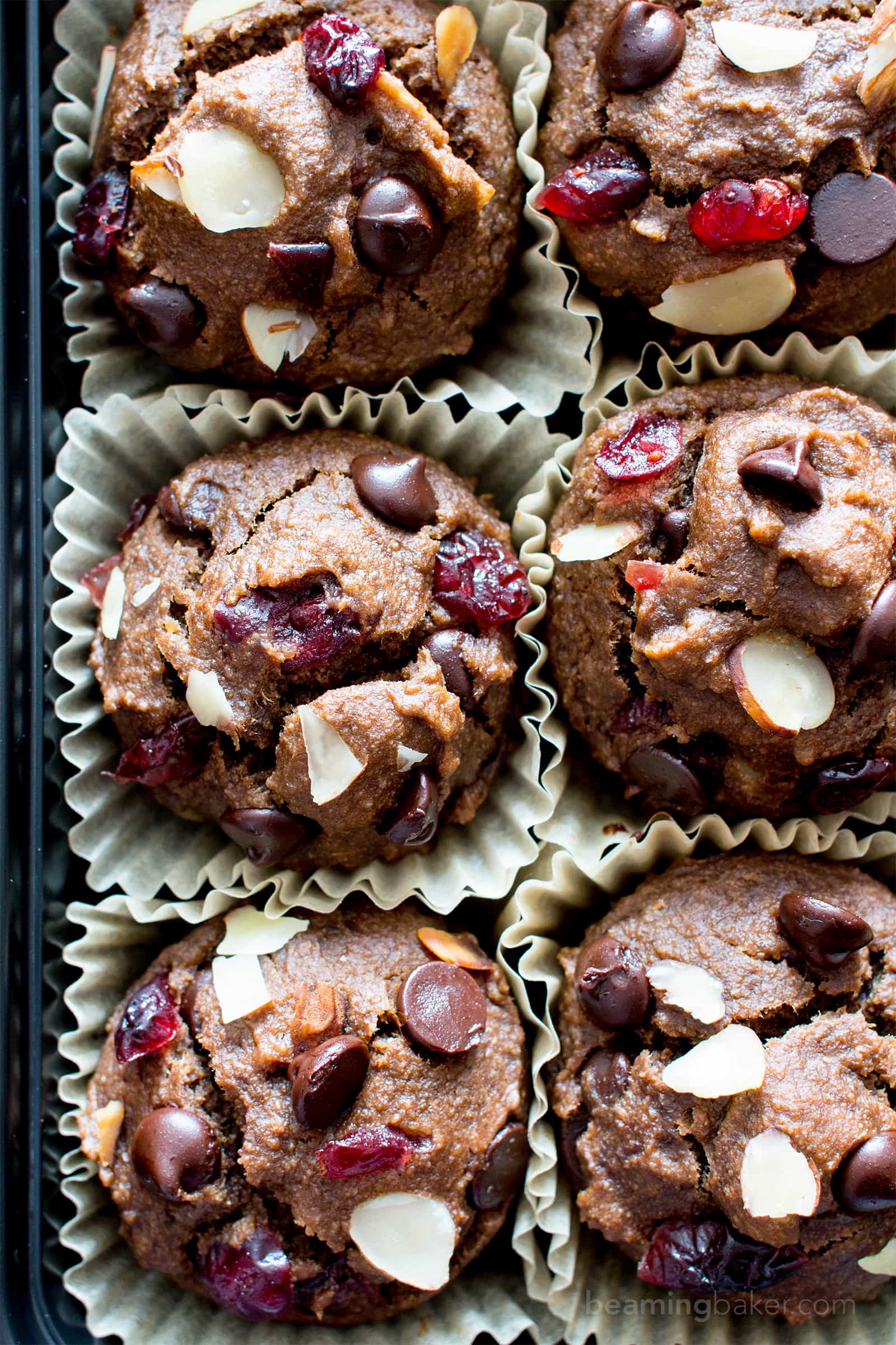 Chocolate Cranberry Almond Banana Muffins Recipe (V, GF): delightfully warm and cozy chocolate banana muffins packed with juicy cranberries and almonds. #Vegan #GlutenFree #DairyFree #Healthy #OneBowl | BeamingBaker.com