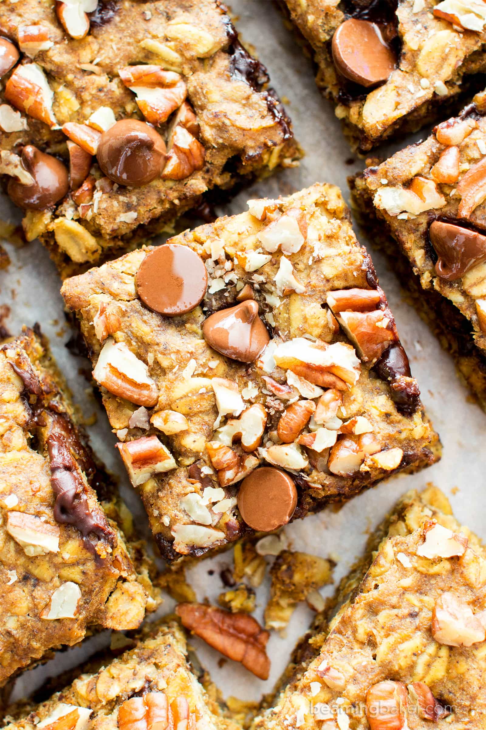 Gluten free pumpkin bars bursting with pumpkin spice goodness. Easy to customize pumpkin oatmeal bars that are vegan. #GlutenFree #Pumpkin #Vegan #PumpkinBars | Recipe at BeamingBaker.com