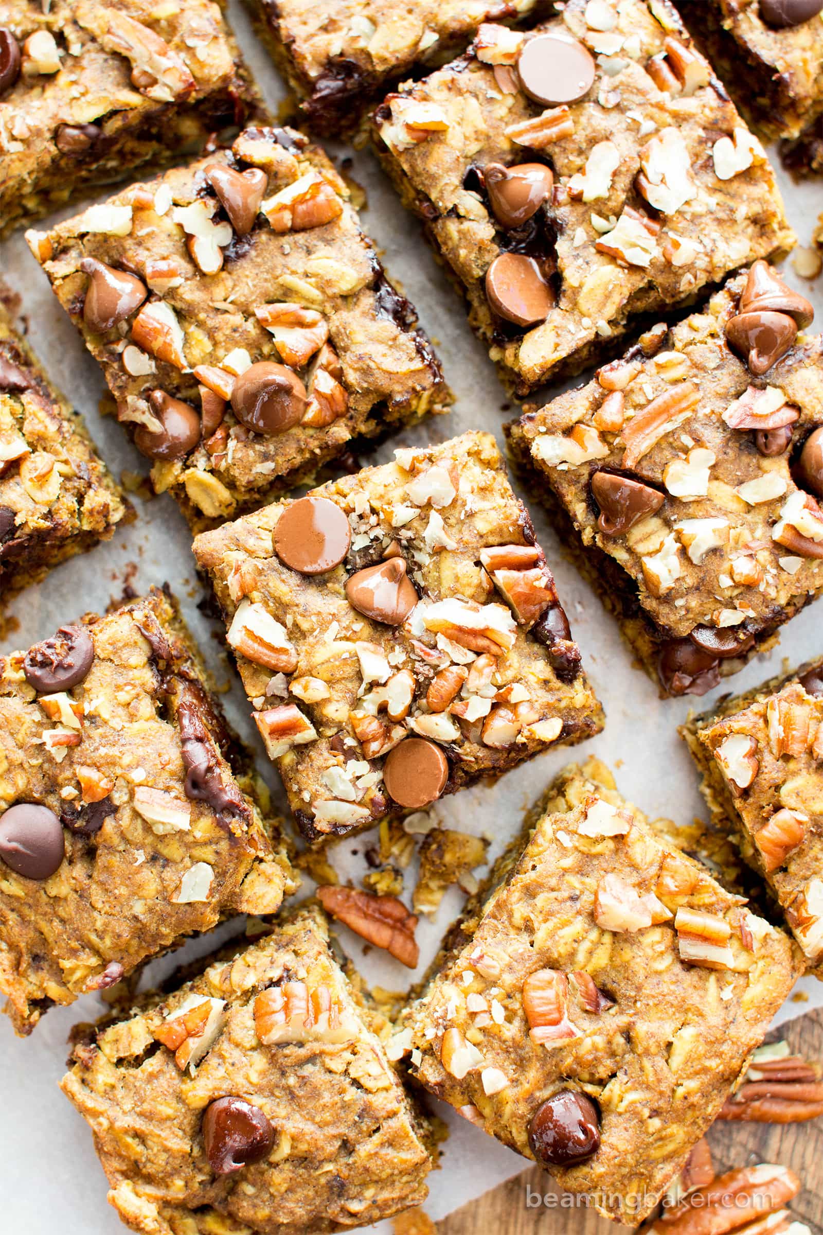 Gluten free pumpkin bars bursting with pumpkin spice goodness. Easy to customize pumpkin oatmeal bars that are vegan. #GlutenFree #Pumpkin #Vegan #PumpkinBars | Recipe at BeamingBaker.com