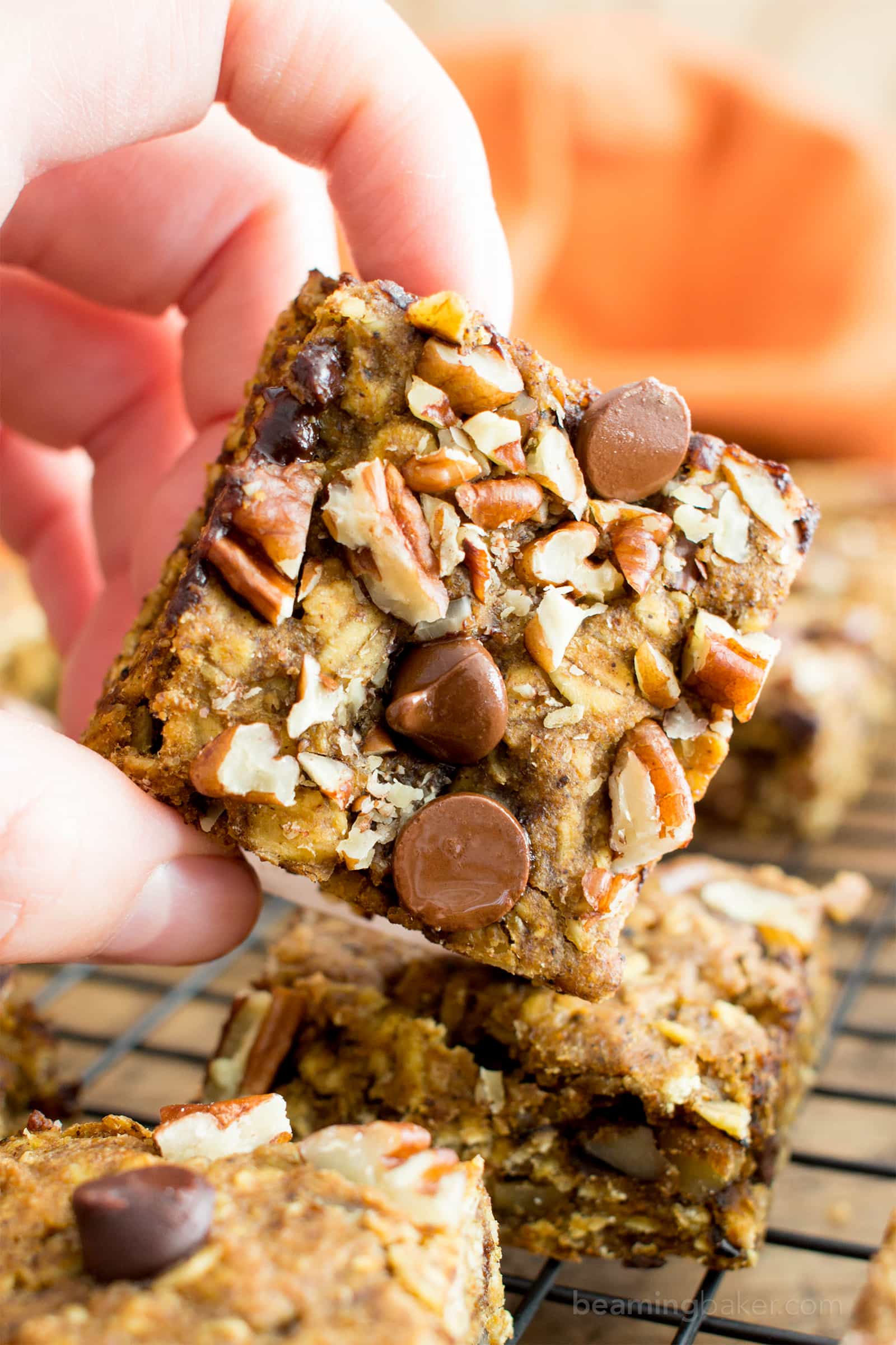 Gluten free pumpkin bars bursting with pumpkin spice goodness. Easy to customize pumpkin oatmeal bars that are vegan. #GlutenFree #Pumpkin #Vegan #PumpkinBars | Recipe at BeamingBaker.com