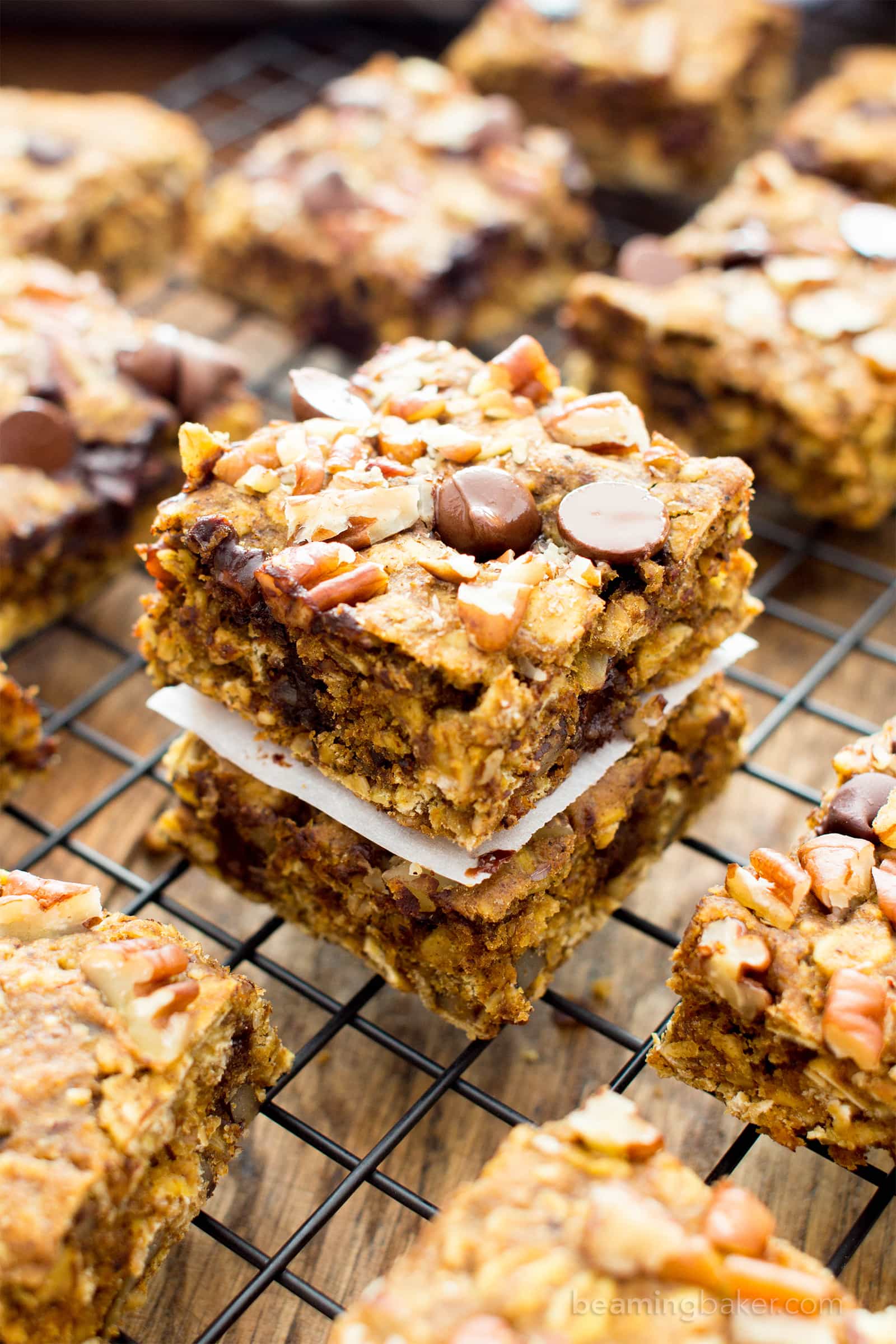 Gluten free pumpkin bars bursting with pumpkin spice goodness. Easy to customize pumpkin oatmeal bars that are vegan. #GlutenFree #Pumpkin #Vegan #PumpkinBars | Recipe at BeamingBaker.com