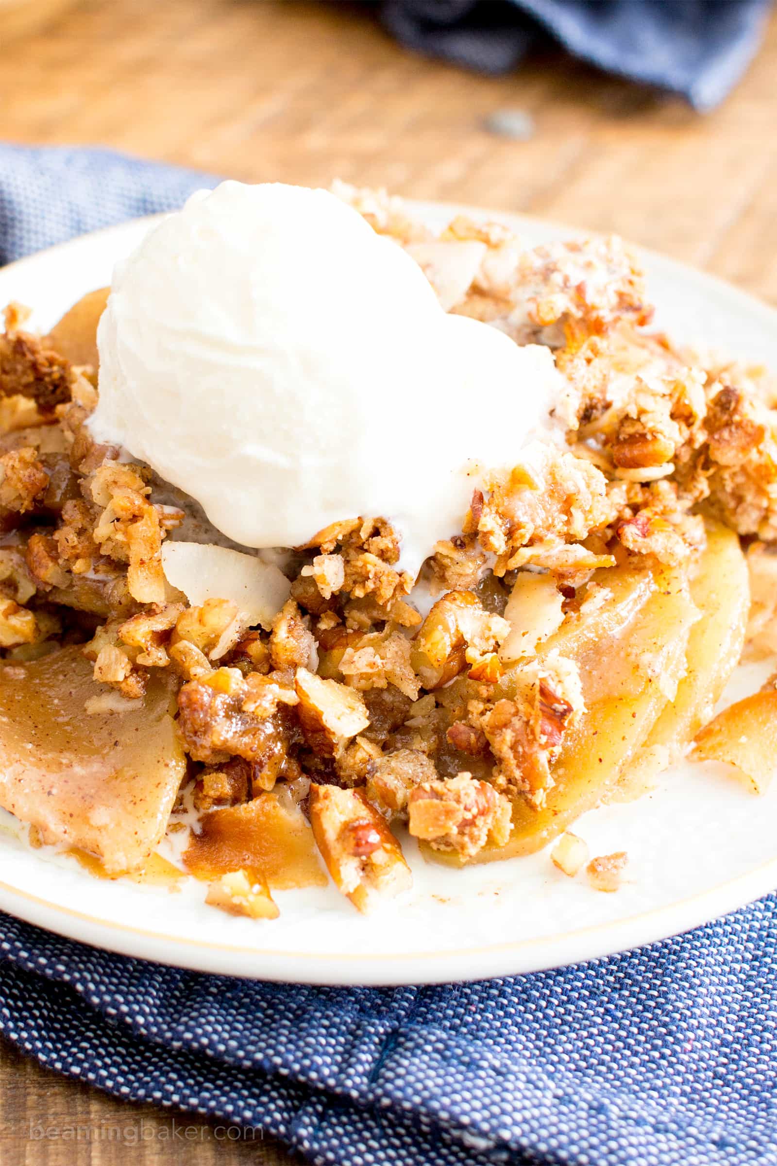 A simple and easy paleo apple crisp recipe that yields gooey cinnamon apple filling with a delicious crisp topping! The best paleo apple crisp made with whole ingredients. #AppleCrisp #Paleo #Apples #AppleCrumble | Recipe at BeamingBaker.com