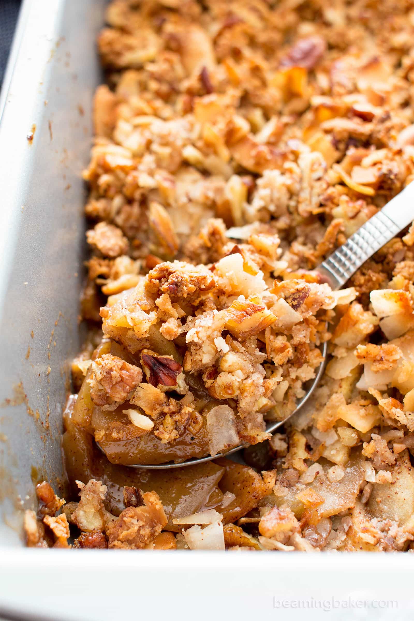 Paleo Apple Pecan Coconut Crisp Recipe (V, GF): a super crisp, nutty topping blanketing a warm, apple cinnamon filling with gooey caramelized coating. #Vegan #Paleo #GlutenFree #DairyFree #Healthy #Fall | BeamingBaker.com