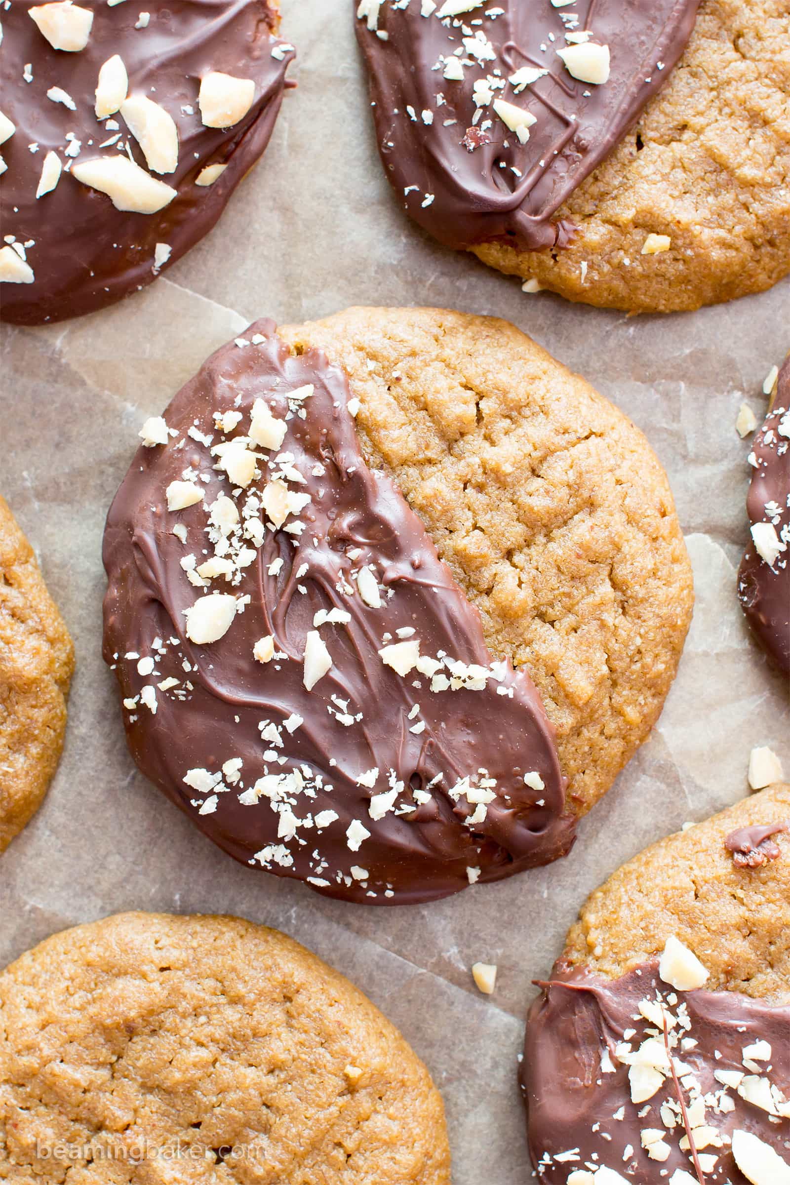 Chocolate Covered Peanut Butter Cookies (V, GF): an easy recipe for soft ‘n chewy peanut butter cookies wrapped in a velvety layer of chocolate and topped with crunchy peanuts. #Vegan #Desserts #GlutenFree #DairyFree #Healthy #Holiday | Recipe on BeamingBaker.com