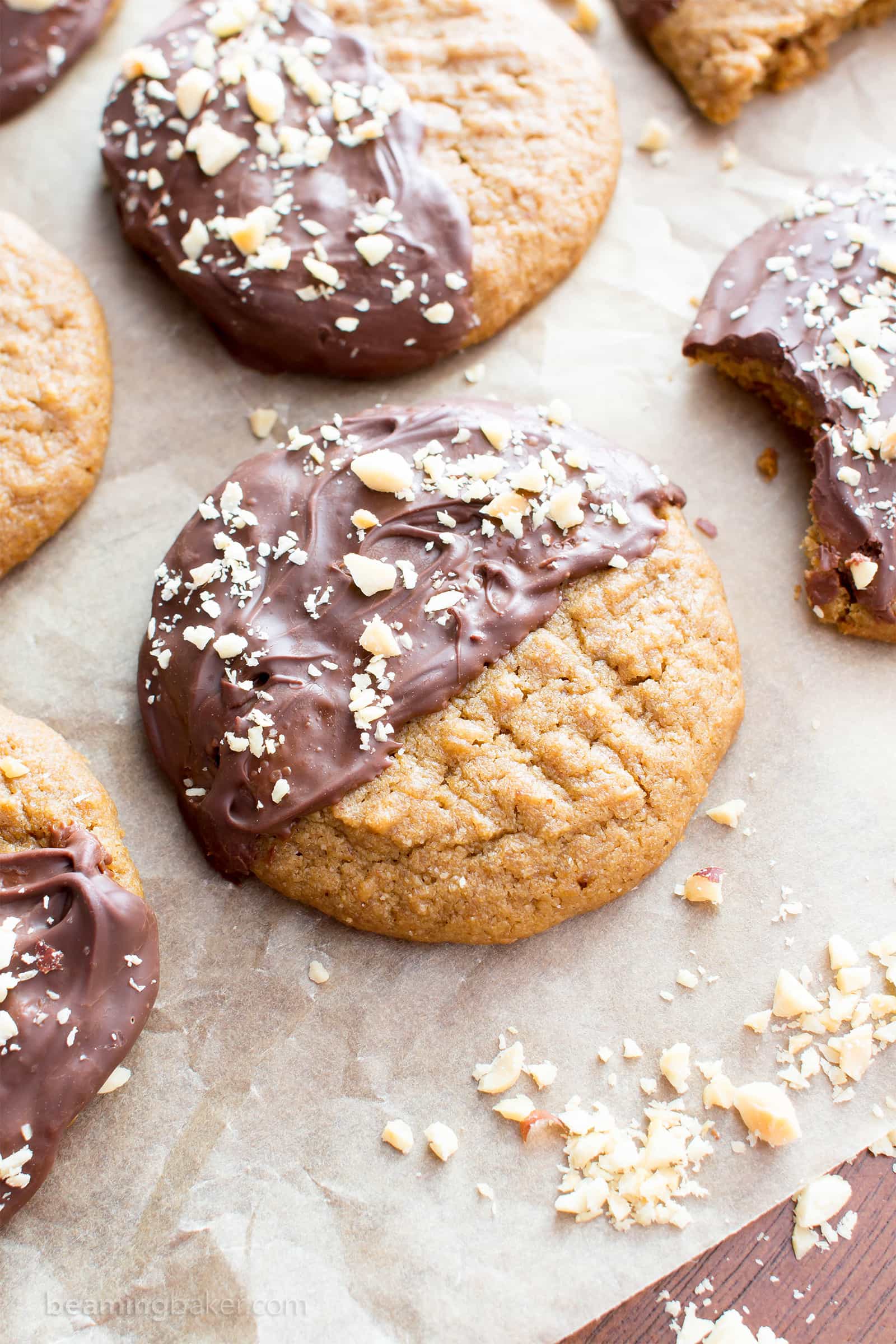 Chocolate Covered Peanut Butter Cookies (V, GF): an easy recipe for soft ‘n chewy peanut butter cookies wrapped in a velvety layer of chocolate and topped with crunchy peanuts. #Vegan #Desserts #GlutenFree #DairyFree #Healthy #Holiday | Recipe on BeamingBaker.com