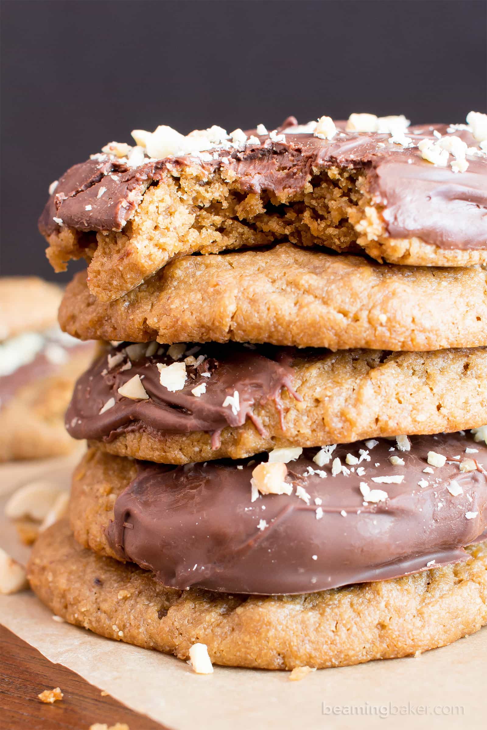 Chocolate Covered Peanut Butter Cookies (V, GF): an easy recipe for soft ‘n chewy peanut butter cookies wrapped in a velvety layer of chocolate and topped with crunchy peanuts. #Vegan #Desserts #GlutenFree #DairyFree #Healthy #Holiday | Recipe on BeamingBaker.com