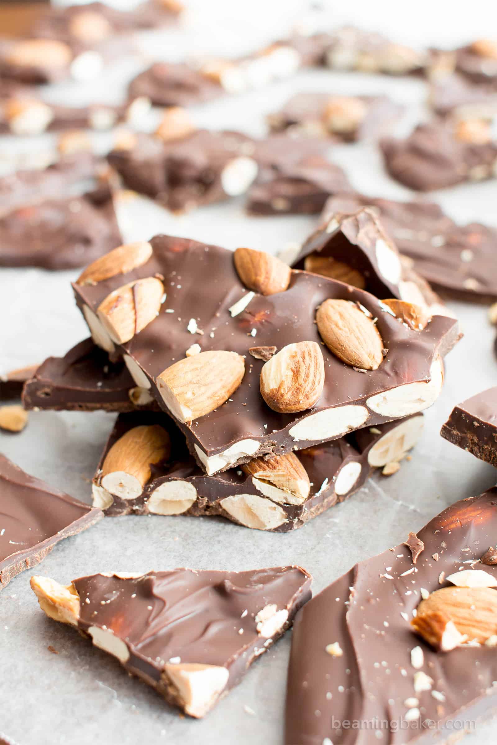 Stack of chocolate almond bark pieces, with more strewn around it