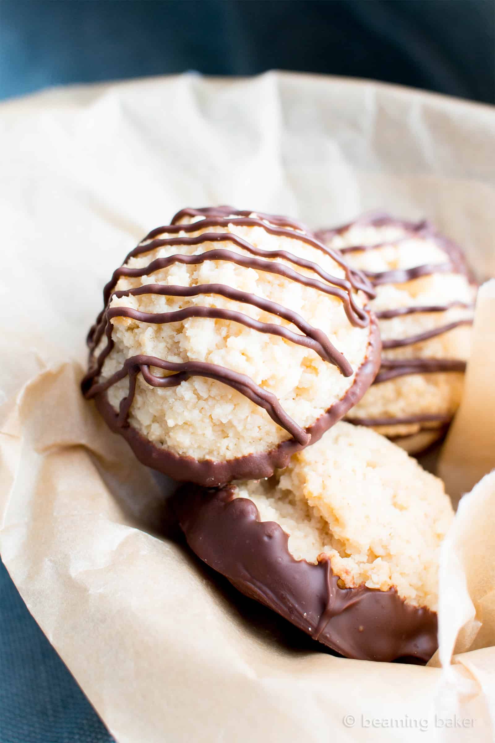 Chocolate Dipped Vegan Coconut Macaroons Recipe (V, GF): an easy recipe for chewy and satisfying chocolate-dipped coconut macaroons made with whole ingredients! #Vegan #Paleo #GlutenFree #DairyFree #Cookies #Coconut #Macaroons #Dessert | Recipe on BeamingBaker.com