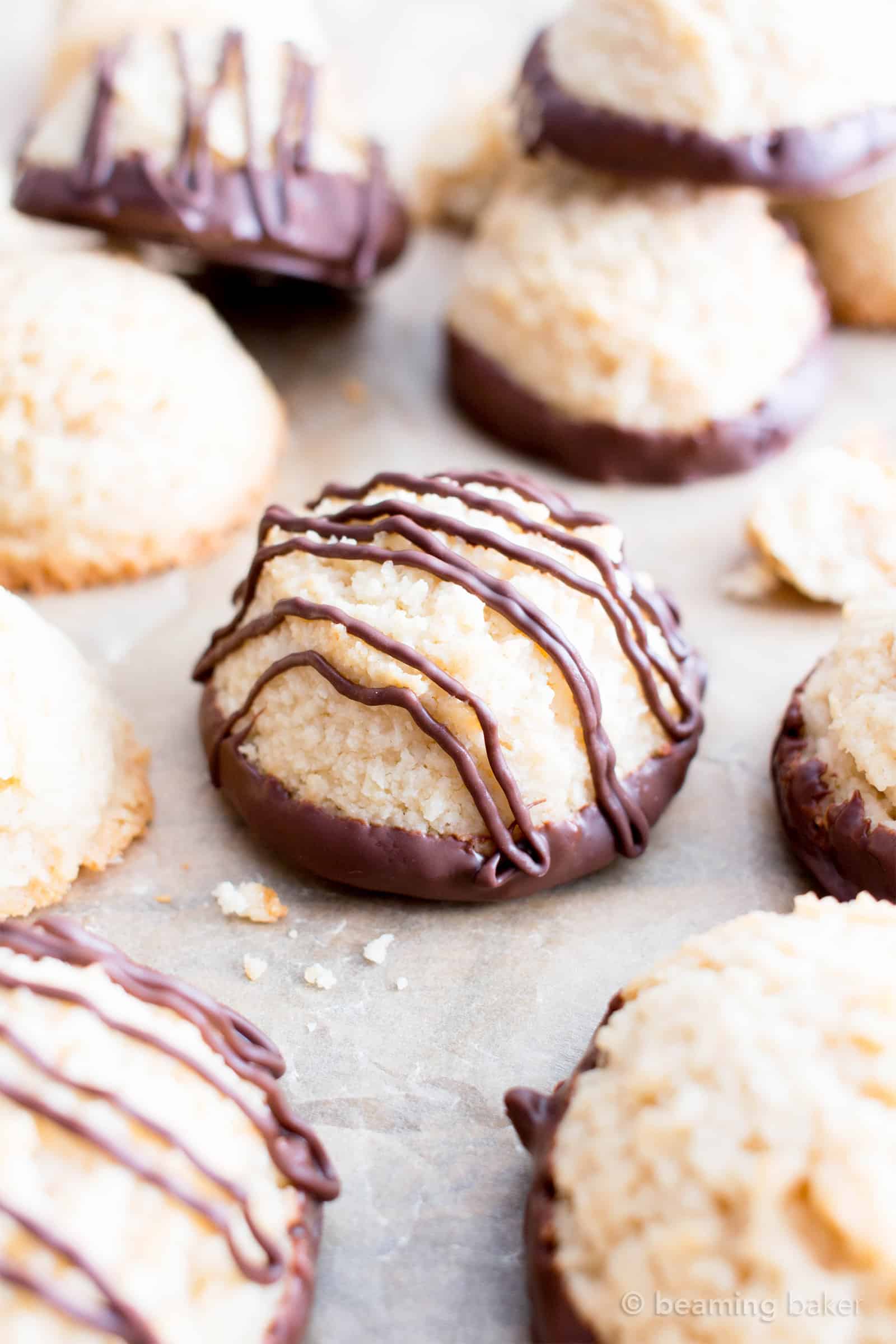 Chocolate Dipped Vegan Coconut Macaroons Recipe (V, GF): an easy recipe for chewy and satisfying chocolate-dipped coconut macaroons made with whole ingredients! #Vegan #Paleo #GlutenFree #DairyFree #Cookies #Dessert | Recipe on BeamingBaker.com