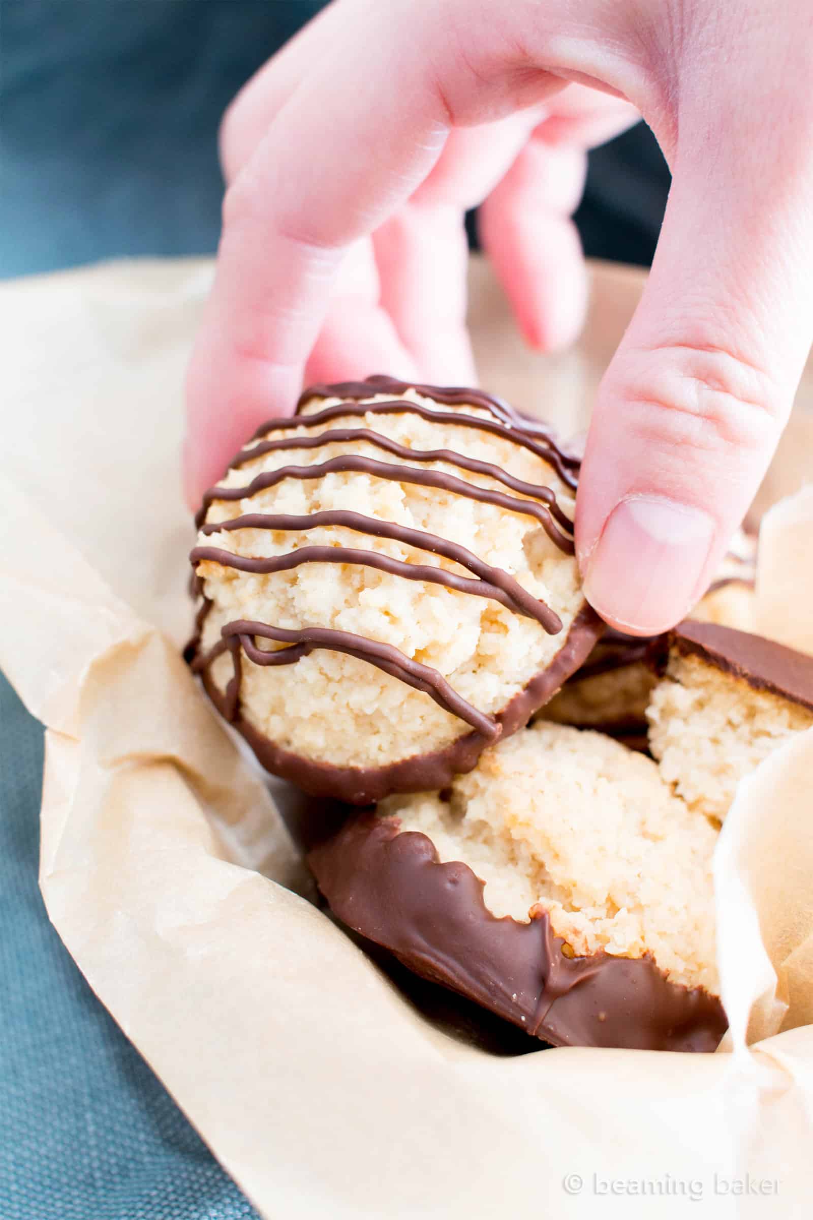 Chocolate Dipped Vegan Coconut Macaroons Recipe (V, GF): an easy recipe for chewy and satisfying chocolate-dipped coconut macaroons made with whole ingredients! #Vegan #Paleo #GlutenFree #DairyFree #Cookies #Dessert | Recipe on BeamingBaker.com