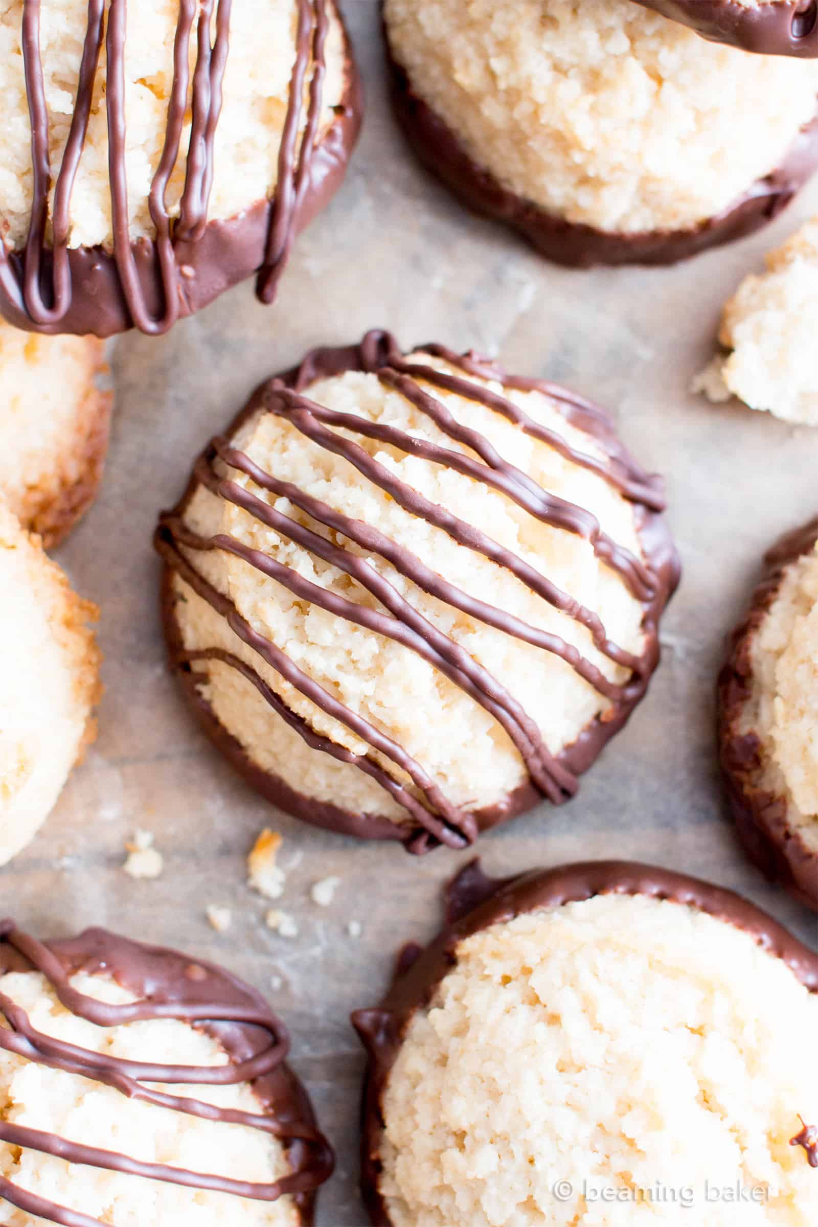 Chocolate Dipped Vegan Coconut Macaroons Recipe (V, GF): an easy recipe for chewy and satisfying chocolate-dipped coconut macaroons made with whole ingredients! #Vegan #Paleo #GlutenFree #DairyFree #Cookies #Dessert | Recipe on BeamingBaker.com