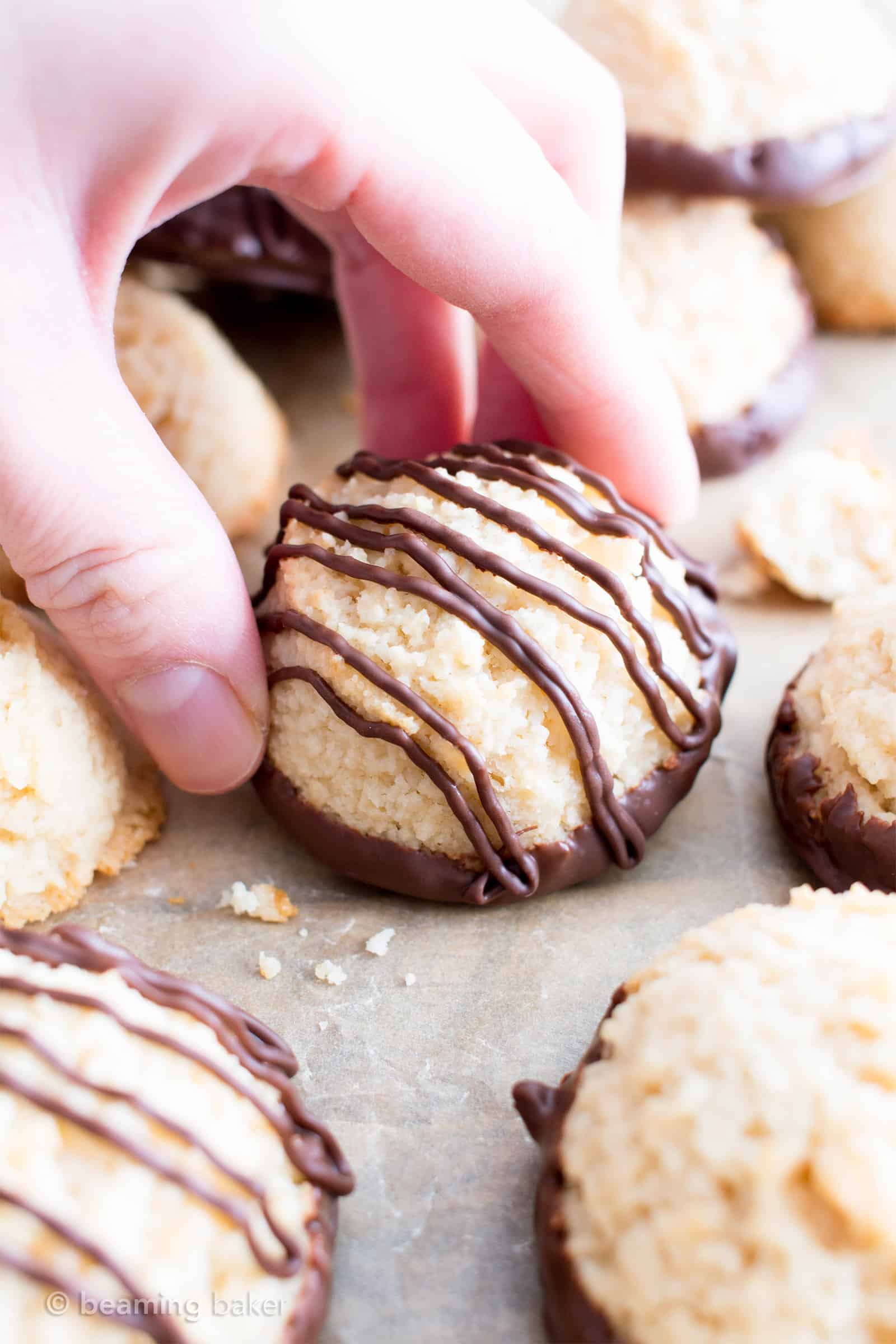 Chocolate Dipped Vegan Coconut Macaroons Recipe (V, GF): an easy recipe for chewy and satisfying chocolate-dipped coconut macaroons made with whole ingredients! #Vegan #Paleo #GlutenFree #DairyFree #Cookies #Dessert | Recipe on BeamingBaker.com